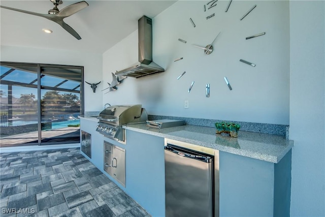 view of patio / terrace with exterior kitchen and a grill