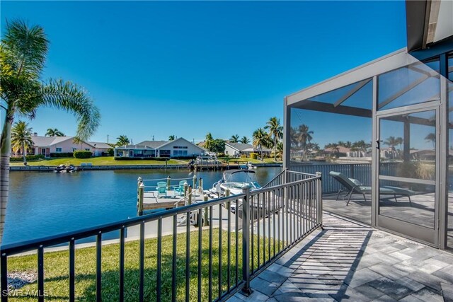 balcony with a water view and a boat dock