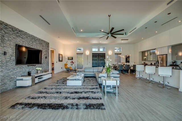 living room featuring ceiling fan and light hardwood / wood-style floors