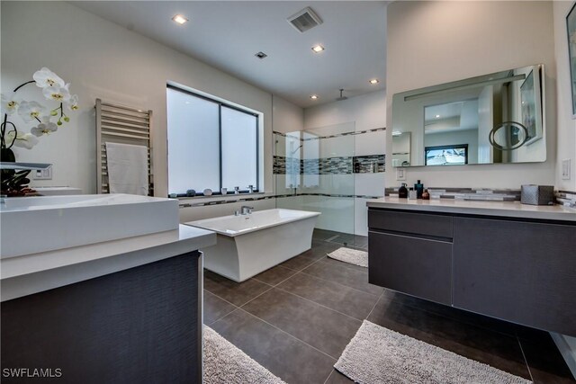 bathroom with vanity, radiator heating unit, tile patterned flooring, and shower with separate bathtub