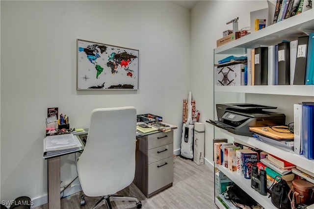 home office featuring light wood-type flooring and baseboards