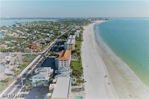 bird's eye view with a water view and a view of the beach