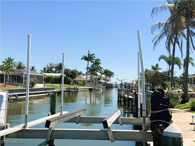 dock area with a lanai and a water view