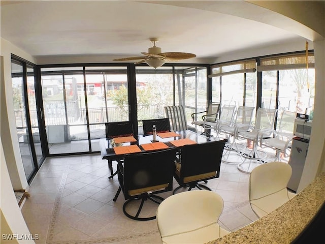 sunroom with a wealth of natural light and ceiling fan