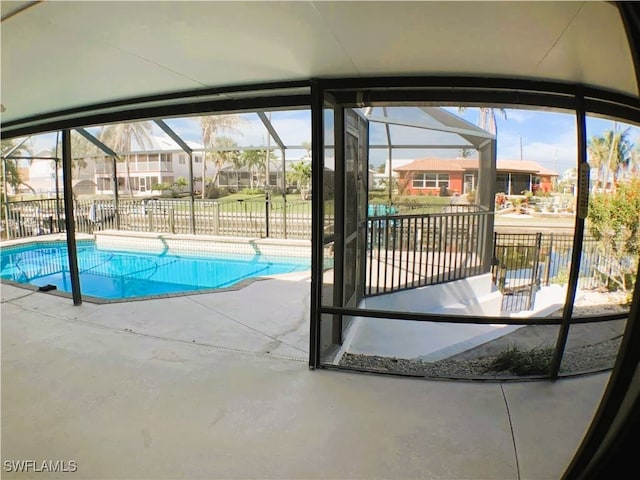 view of swimming pool with a lanai and a patio area