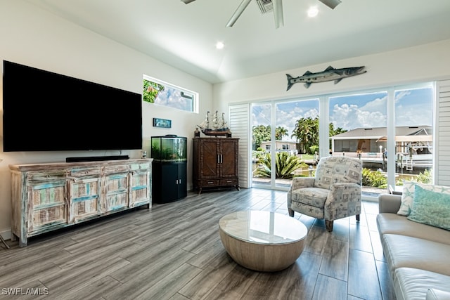 living room with vaulted ceiling, hardwood / wood-style floors, and ceiling fan