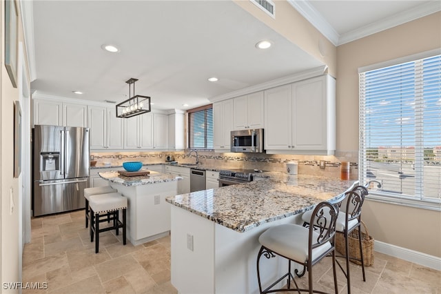 kitchen with pendant lighting, backsplash, a breakfast bar area, a kitchen island, and stainless steel appliances