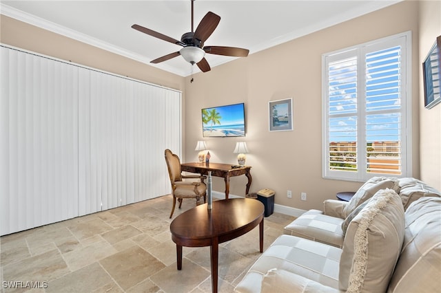 living room featuring ceiling fan and crown molding