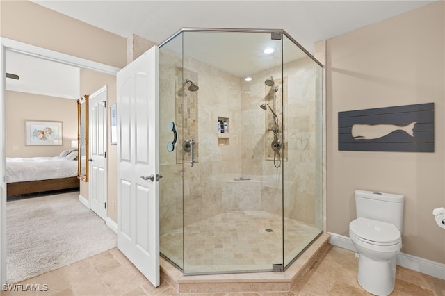 bathroom featuring toilet and an enclosed shower