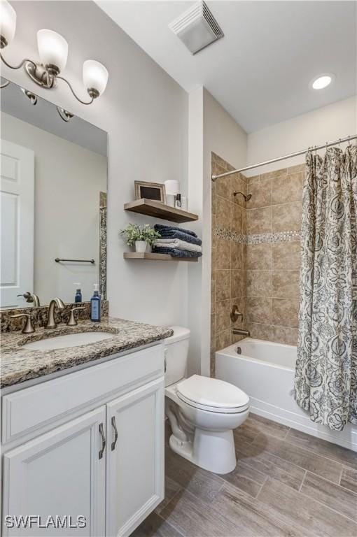 bathroom with visible vents, shower / bath combo with shower curtain, toilet, and vanity