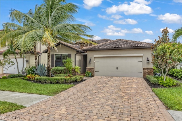 view of front of home with stone siding, stucco siding, decorative driveway, and a garage