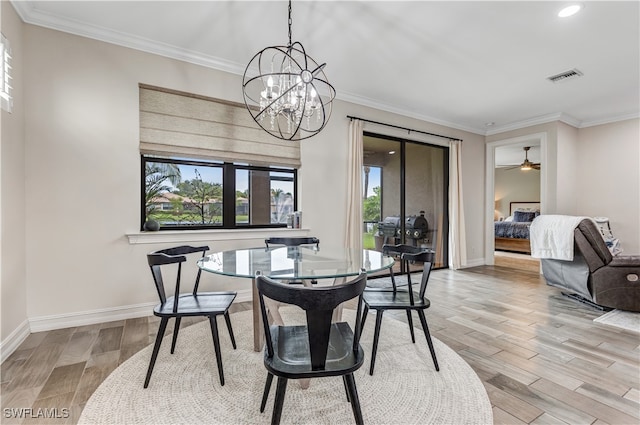 dining room featuring baseboards, wood finished floors, visible vents, and ornamental molding