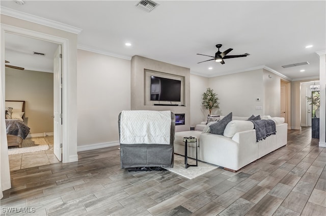 living room featuring ceiling fan, hardwood / wood-style floors, and ornamental molding