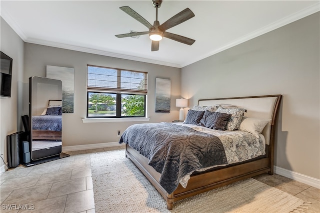 tiled bedroom featuring crown molding, a ceiling fan, and baseboards