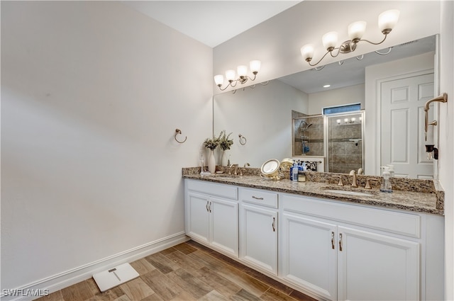 bathroom featuring vanity, hardwood / wood-style flooring, and a shower with door