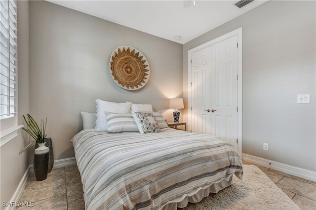 bedroom featuring light tile patterned flooring and a closet