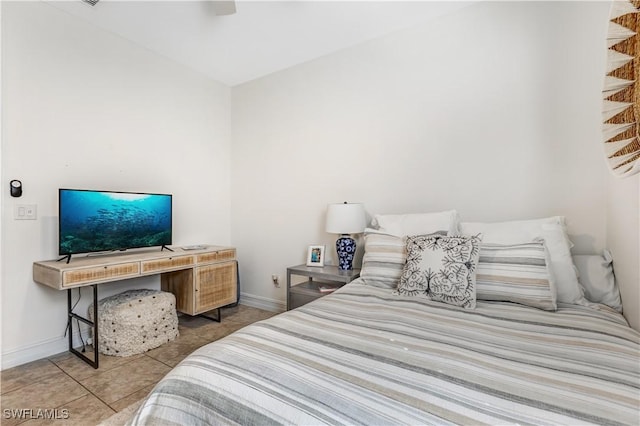 tiled bedroom featuring ceiling fan and baseboards