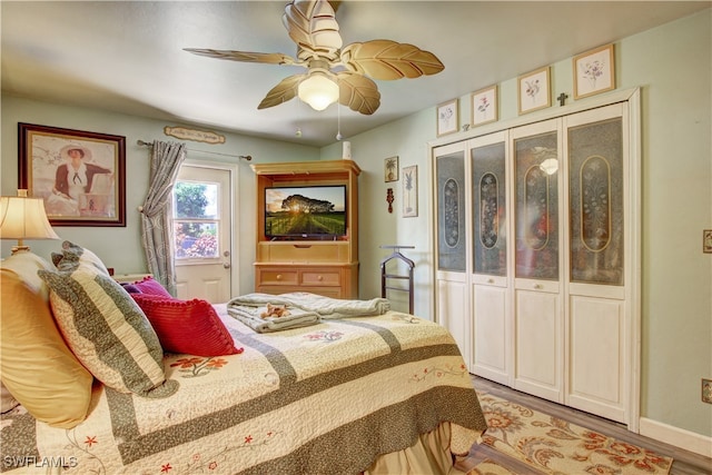 bedroom featuring ceiling fan, light wood-type flooring, and a closet