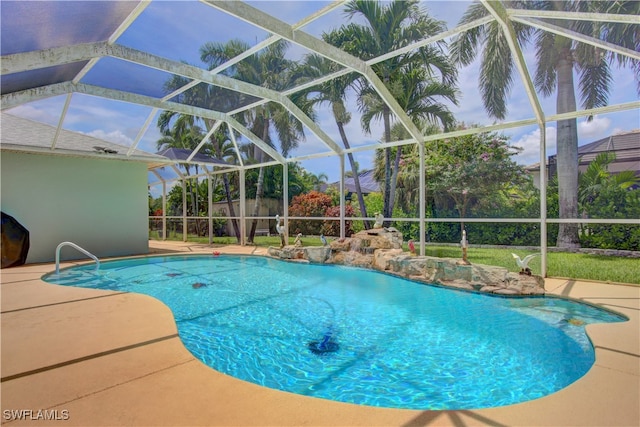 view of swimming pool with glass enclosure and a patio