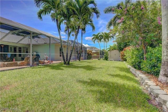 view of yard featuring a lanai and a shed