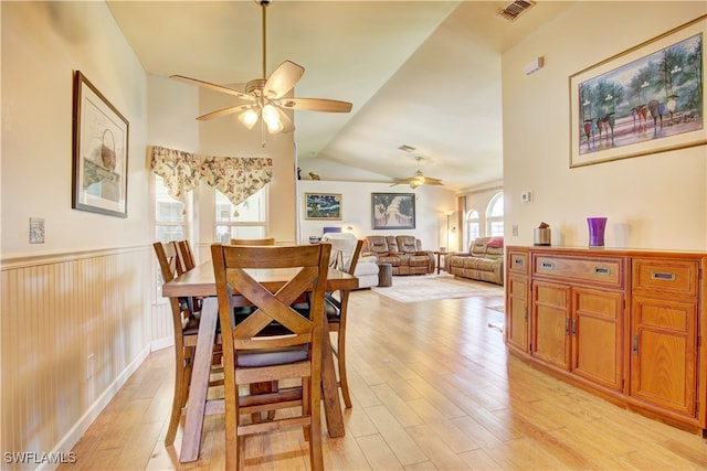 dining space featuring light hardwood / wood-style floors, ceiling fan, and lofted ceiling