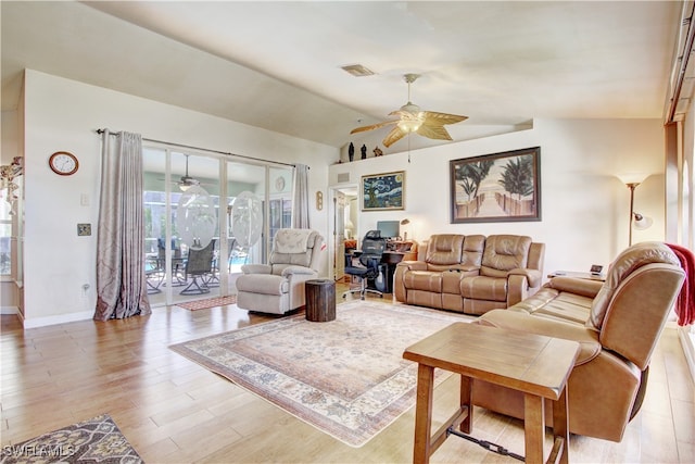 living room with light hardwood / wood-style flooring and lofted ceiling