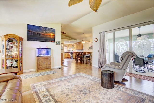 living room featuring ceiling fan, plenty of natural light, light hardwood / wood-style floors, and lofted ceiling