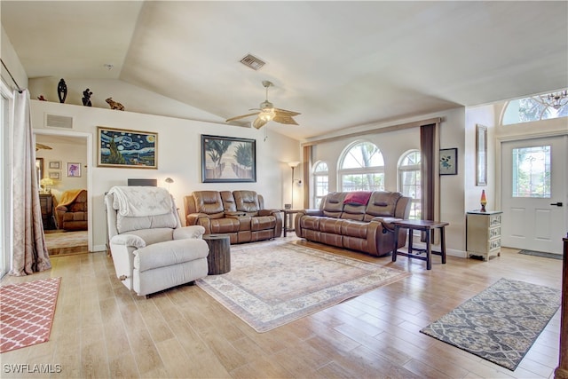 living room featuring ceiling fan, light hardwood / wood-style floors, and lofted ceiling