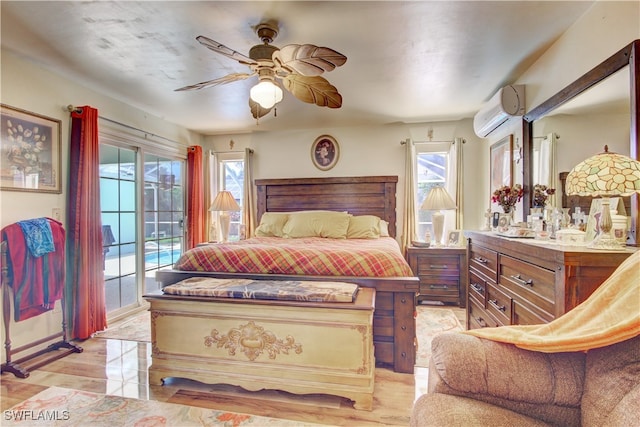 bedroom featuring a wall unit AC, multiple windows, ceiling fan, and access to outside