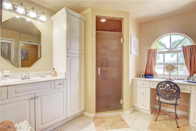 bathroom featuring tile patterned flooring, vanity, and a shower with shower door