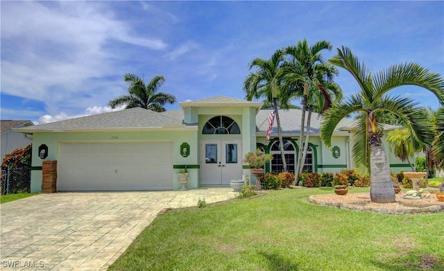 view of front of property with a garage and a front lawn