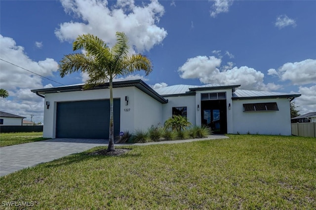 view of front facade featuring a front yard and a garage