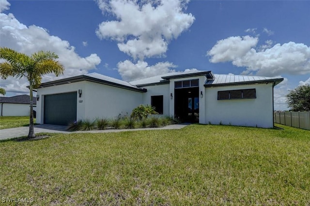 view of front of house featuring a front yard and a garage