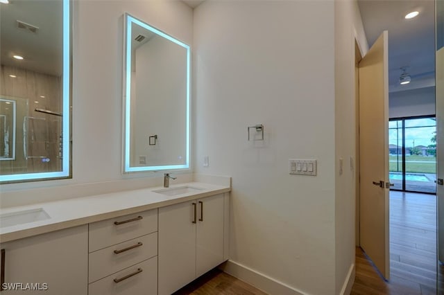 bathroom featuring hardwood / wood-style flooring and vanity