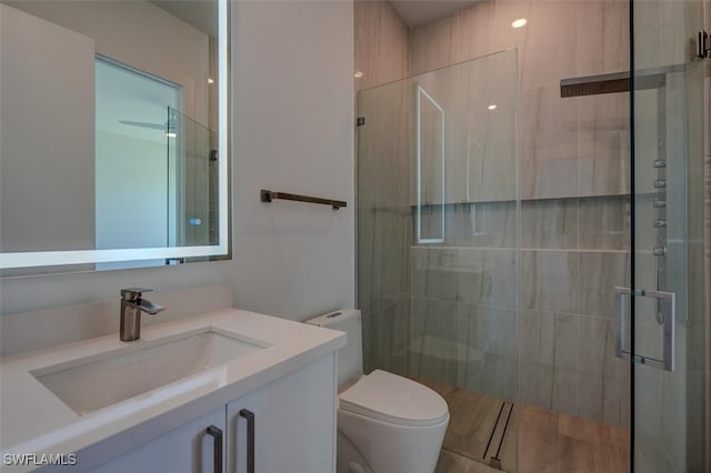 bathroom with vanity, toilet, and walk in shower