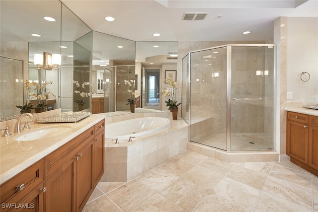 bathroom with independent shower and bath and vanity