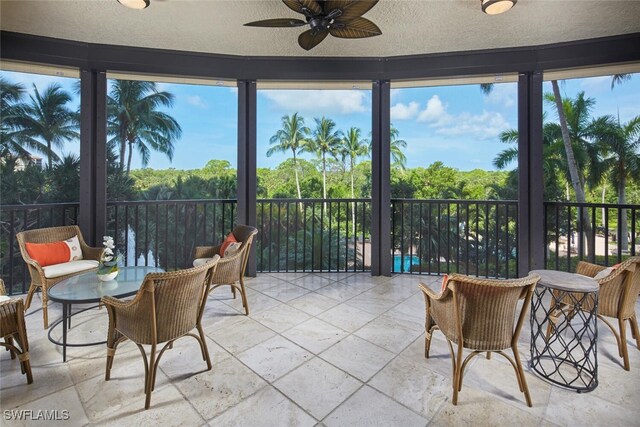 sunroom featuring ceiling fan and a healthy amount of sunlight