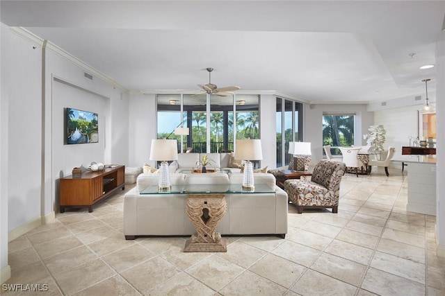 living room featuring light tile patterned floors, crown molding, and ceiling fan