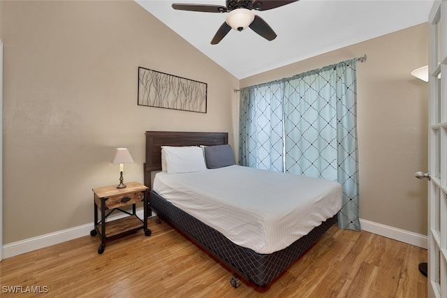 bedroom featuring light hardwood / wood-style flooring, ceiling fan, and vaulted ceiling