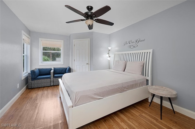 bedroom with light hardwood / wood-style floors and ceiling fan