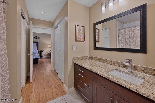 bathroom featuring hardwood / wood-style flooring and vanity