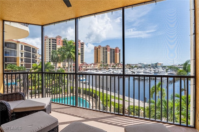 sunroom with a water view and a wealth of natural light