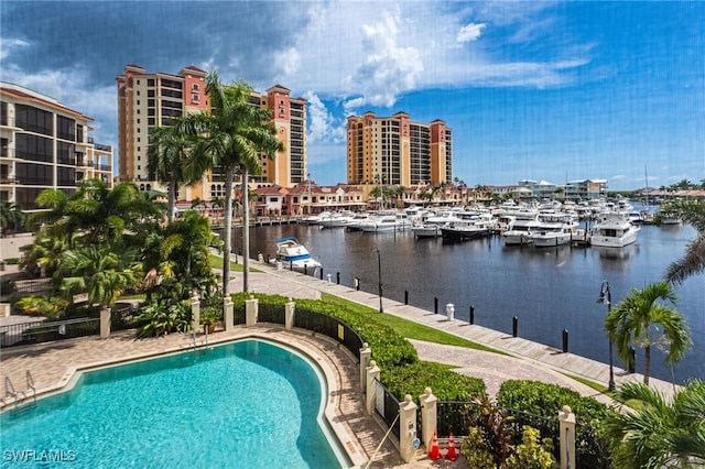 view of pool with a water view and a patio area