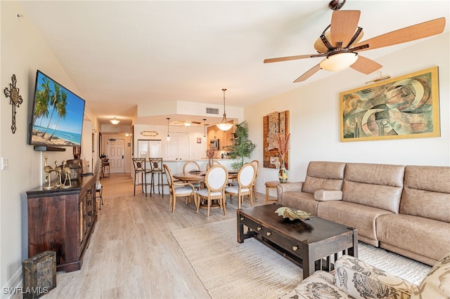 living room with ceiling fan and light hardwood / wood-style floors