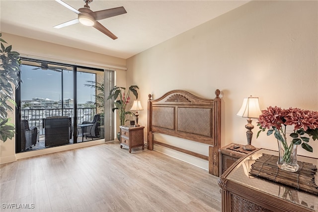 bedroom featuring ceiling fan, light wood-type flooring, and access to outside