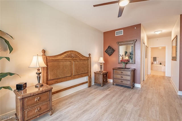 bedroom featuring connected bathroom, light hardwood / wood-style flooring, and ceiling fan