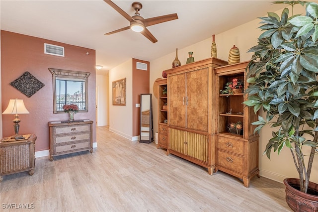 sitting room featuring ceiling fan and light wood-type flooring