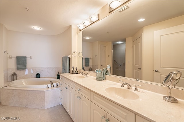 bathroom with plus walk in shower, tile patterned floors, and vanity