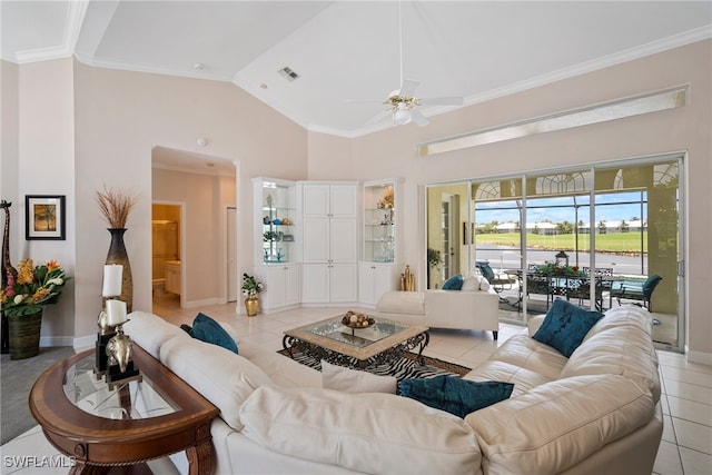 living room with light tile patterned flooring, ornamental molding, and high vaulted ceiling