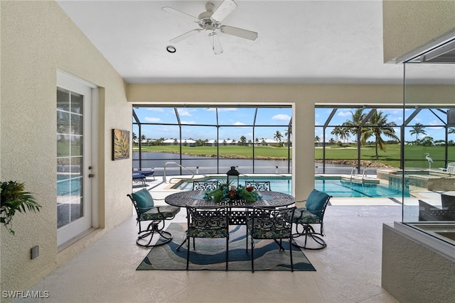 sunroom / solarium featuring ceiling fan, plenty of natural light, and a swimming pool